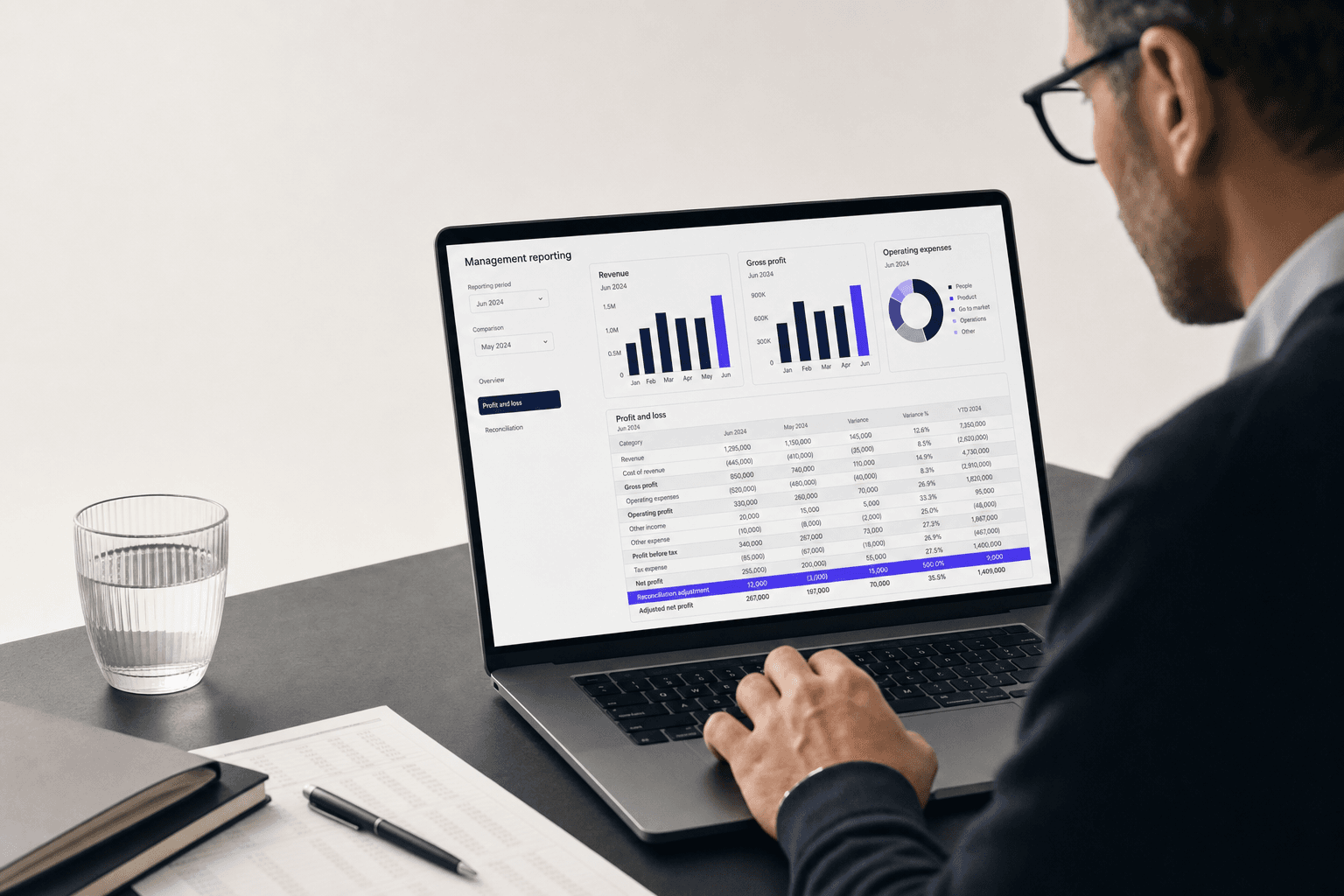 Finance lead reviewing a management reporting dashboard with drill-down P&L data